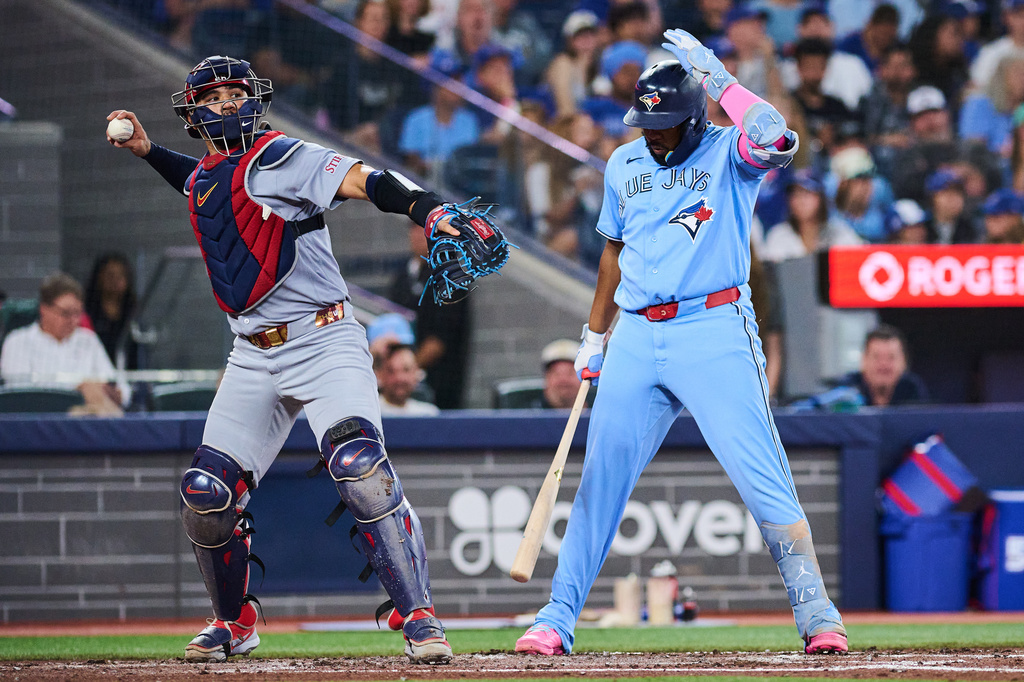 Toronto Blue Jays' Vladimir Guerrero Jr., right, unsuccessfully challenges a strike call during the fourth inning of a baseball game against the St. Louis Cardinals in Toronto, Sunday, Aug. 2, 2026. (Sammy Kogan/The Canadian Press via AP)