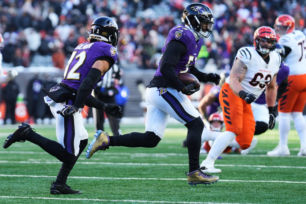Baltimore Ravens linebacker Kyle van Noy (53), with safety Alohi Gilman (12) running next to him, returns an interception during the second half of an NFL football game against the Cincinnati Bengals, Sunday, Dec. 14, 2025, in Cincinnati. (AP Photo/Jeff Dean)