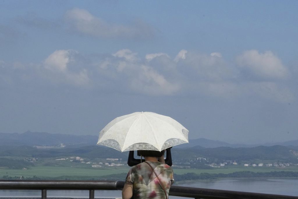 A visitor watches North Korean side from the Unification Observation in Paju, South Korea, near the border with North Korea, Sunday, Aug. 10, 2025. (AP Photo/Ahn Young-joon)