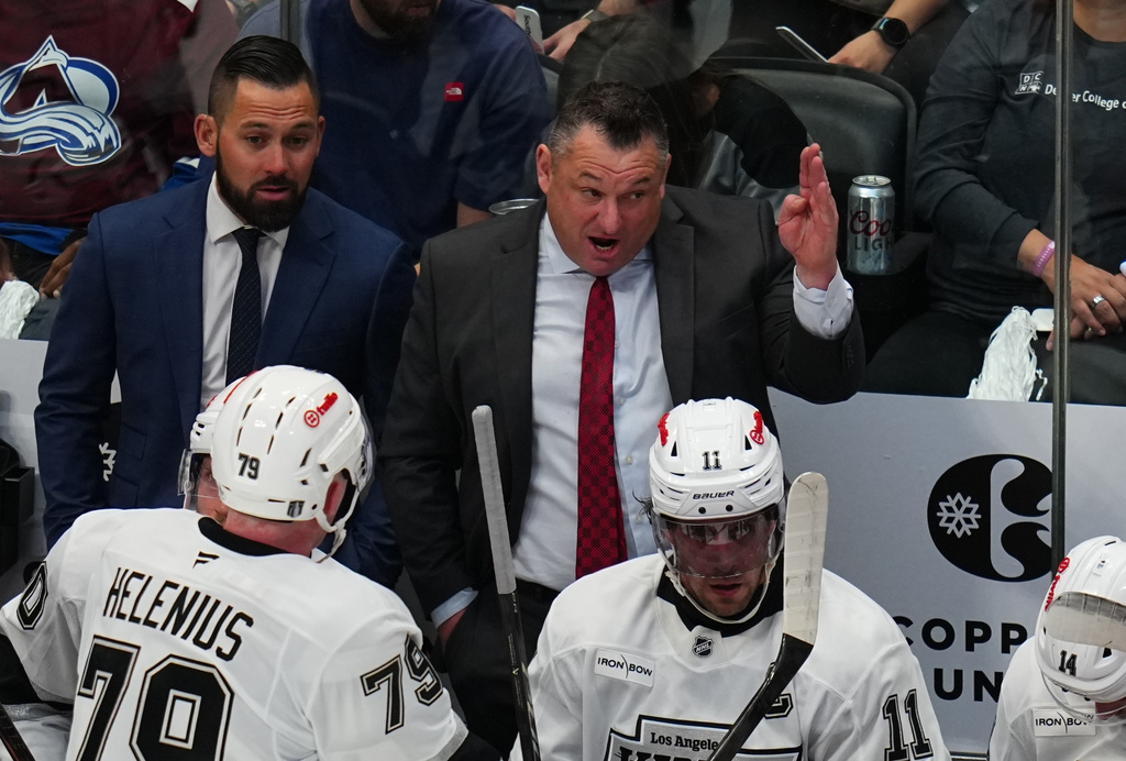 Los Angeles Kings interim coach D.J. Smith talks with center Samuel Helenius (79) during the first period of Game 2 in the first round of the NHL hockey Stanley Cup playoffs against the Colorado Avalanche, Tuesday, April 21, 2026, in Denver. (AP Photo Jack Dempsey)