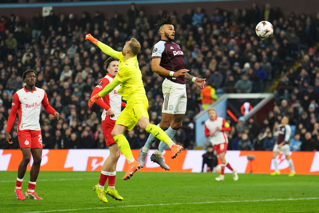 Aston Villa's Tyrone Mings, top, scores during the Europa League opening phase soccer match between Aston Villa and RB Salzburg in Birmingham, England, Thursday Jan. 29, 2026. (Martin Rickett/PA via AP)