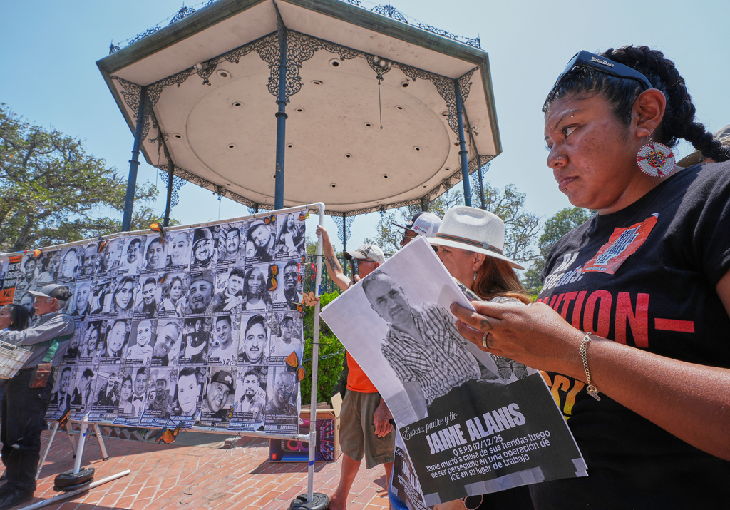 FILE - Activist and farm worker Xochitl Nunez, right, holds up a picture of late farm worker Jaime Alanis as she joins farmworkers, immigrant leaders, labor allies and organizers to announce a national, "Farmworker Strike for Dignity," during a news conference at La Placita Olvera in Los Angeles, July 14, 2025. (AP Photo/Damian Dovarganes, File)