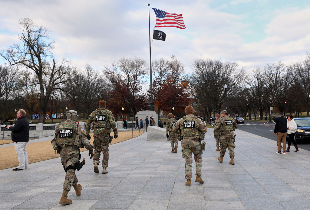 National Guard patrol the National Mall near the Lincoln Memorial, Friday, Nov. 28, 2025, in Washington. (AP Photo/Rahmat Gul)