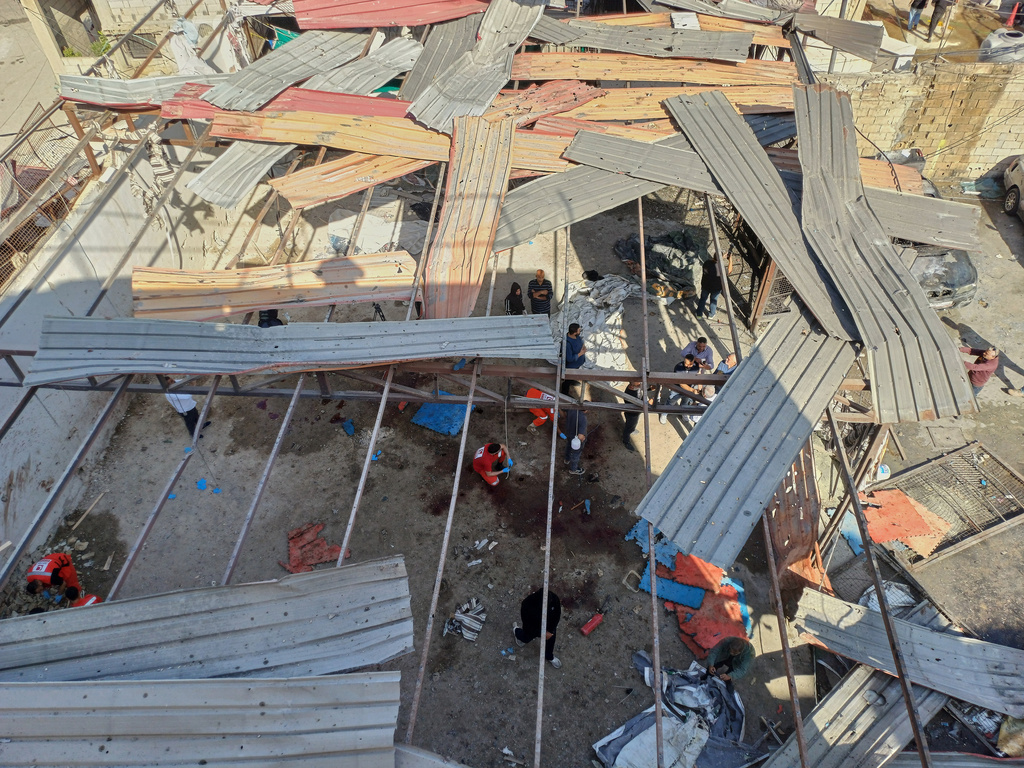 Palestinian rescue workers collect body remains at the scene where an Israeli strike on Tuesday night hit the Ein el-Hilweh Palestinian refugee camp, in the southern port city of Sidon, Lebanon, Wednesday, Nov. 19, 2025. (AP Photo/Mohammed Zaatari)