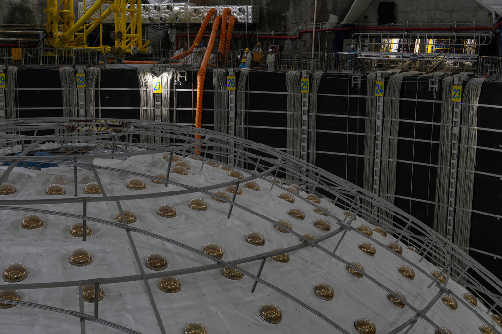 FILE - Workers labor near the cosmic detector housed underground at the Jiangmen Underground Neutrino Observatory in Kaiping in southern China's Guangdong province, Oct. 11, 2024. (AP Photo/Ng Han Guan, File)