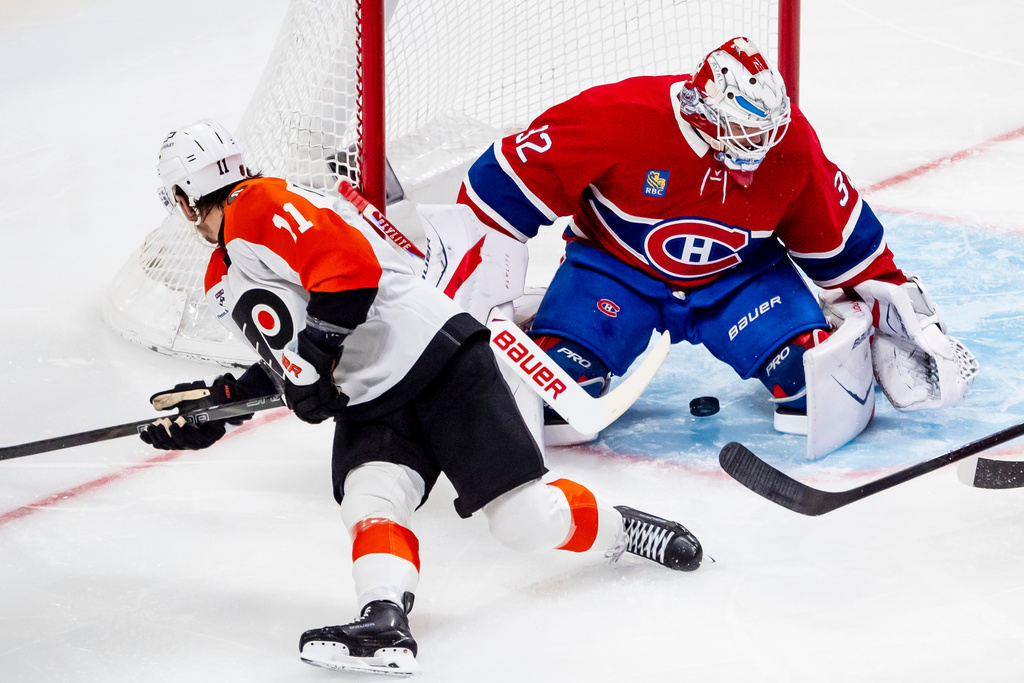 Montreal Canadiens goaltender Jacob Fowler (32) makes a save on Philadelphia Flyers' Travis Konecny (11) during second period NHL hockey action in Montreal on Tuesday, Dec. 16, 2025. (Christopher Katsarov/The Canadian Press via AP)
