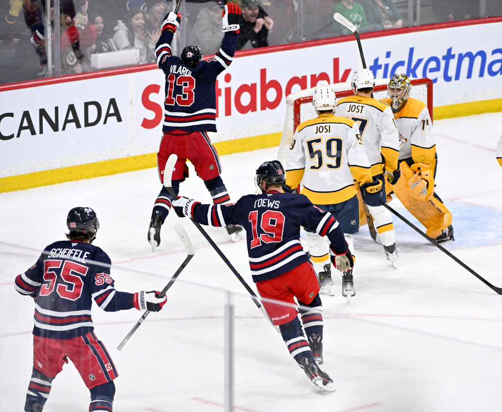 Winnipeg Jets' Jonathan Toews (19) celebrates his goal on the Nashville Predators during the third period of their NHL hockey game in Winnipeg, Tuesday March 17, 2026. (Fred Greenslade/The Canadian Press via AP)