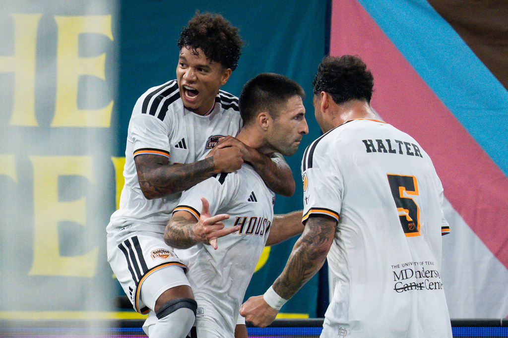 Houston Dynamo FC's Franco Negri, center, celebrates his goal against the Vancouver Whitecaps with Lawrence Ennali, left, and Lucas Halter during the first half of an MLS soccer match in Vancouver, B.C., on Wednesday, Aug. 19, 2026. (Ethan Cairns/The Canadian Press via AP)