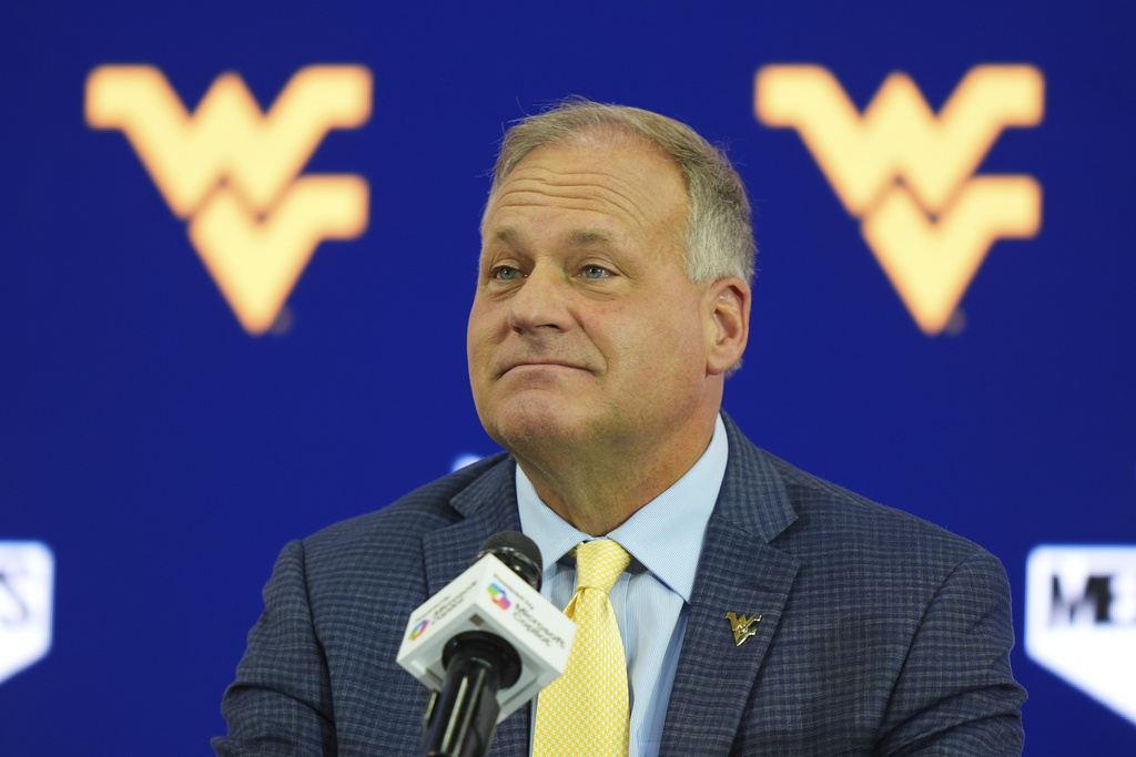 West Virginia head coach Rich Rodriguez listens to a question during the Big 12 NCAA college football media day in Frisco, Texas, Wednesday, July 9, 2025. (AP Photo/LM Otero)