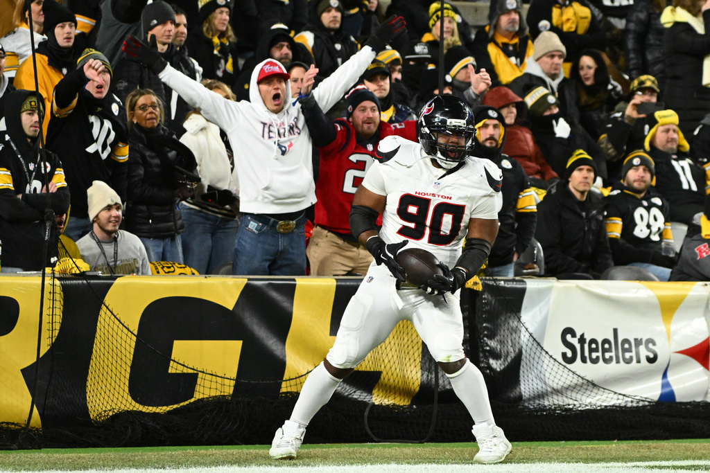 Houston Texans defensive tackle Sheldon Rankins celebrates after a touchdown during the second half of an NFL wild-card playoff football game against the Pittsburgh Steelers, Monday, Jan. 12, 2026, in Pittsburgh. (AP Photo/Justin Berl)