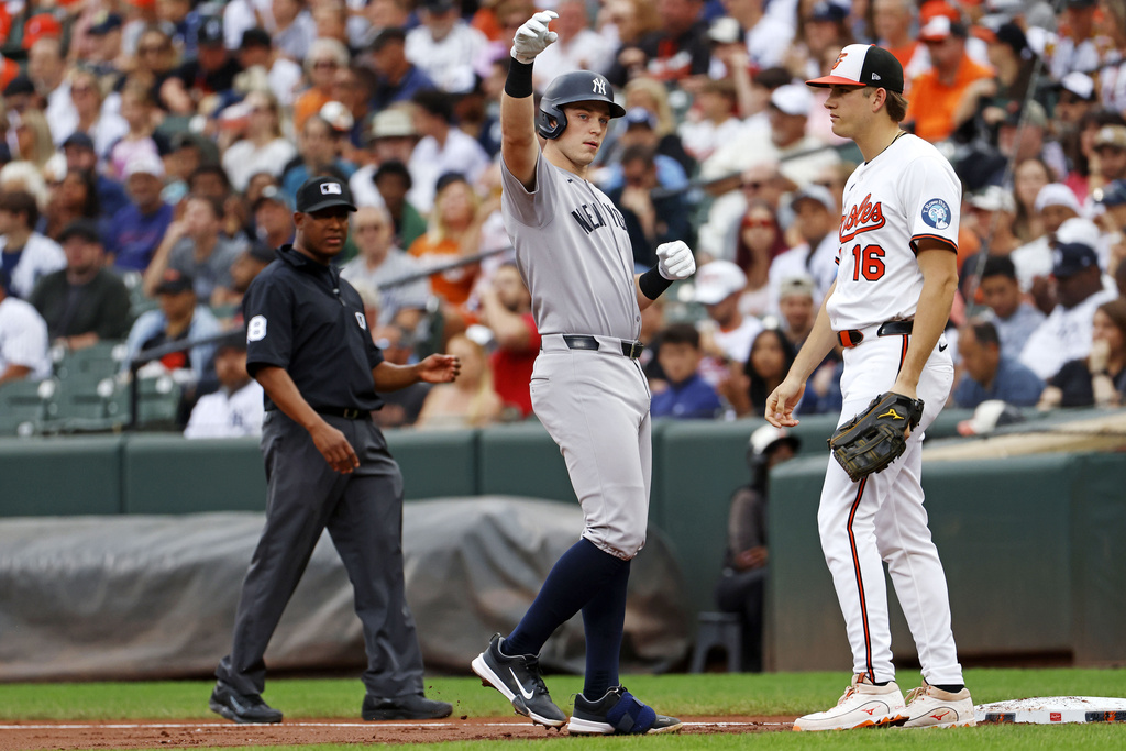 New York Yankees Ben Rice (22), center, celebrates toward his dugout after hitting a single during the second inning of a baseball against the Baltimore Orioles, Sunday, Sept. 21, 2025, in Baltimore. (AP Photo/Peter Casey)