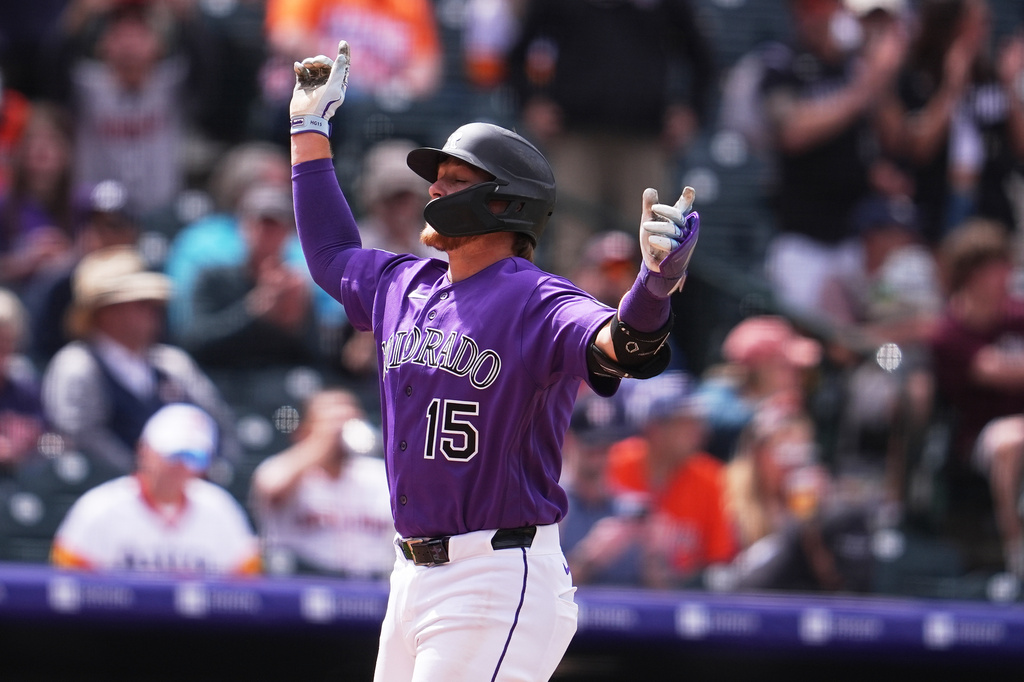 Colorado Rockies' Hunter Goodman celebrates as he crosses home plate after hitting a solo home run off Houston Astros relief pitcher Enyel de Los Santos in the fourth inning of a baseball game Wednesday, April 8, 2026, in Denver. (AP Photo/David Zalubowski)