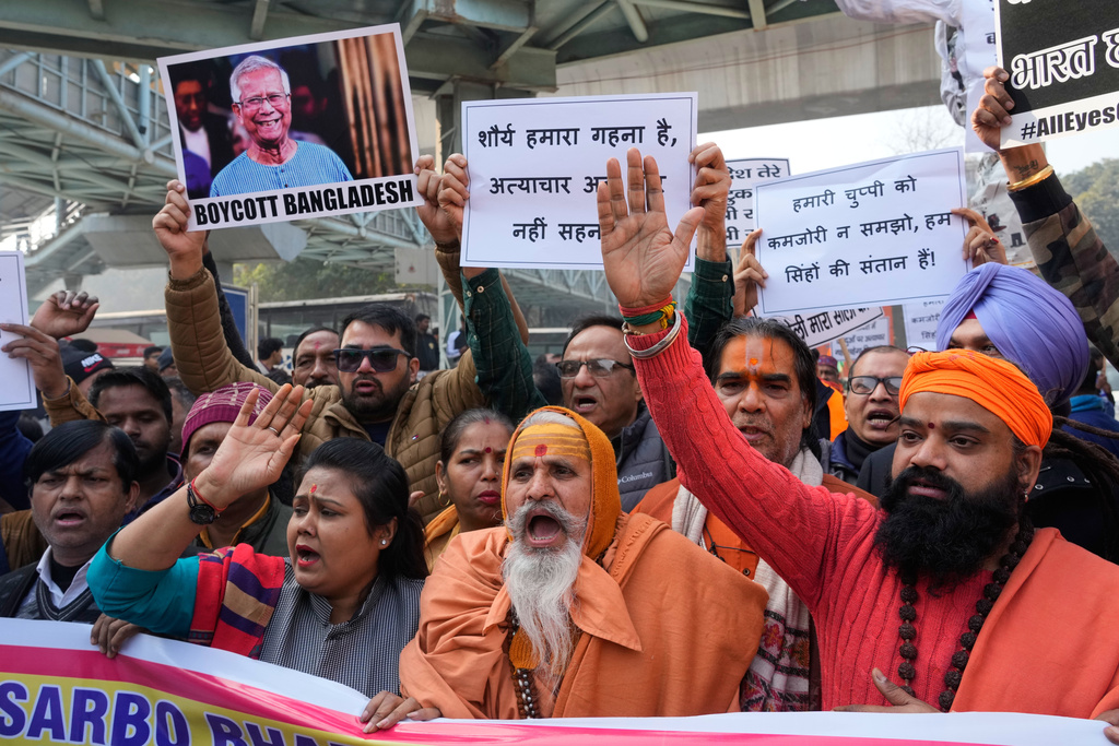 Activists of Vishwa Hindu Parishad, a prominent right-wing Hindu nationalist organization, shout slogans during a protest near Bangladesh High Commission accusing Bangladeshi groups of wrongly targeting Indians, in New Delhi, India, Tuesday, Dec.23, 2025. (AP Photo/Manish Swarup)
