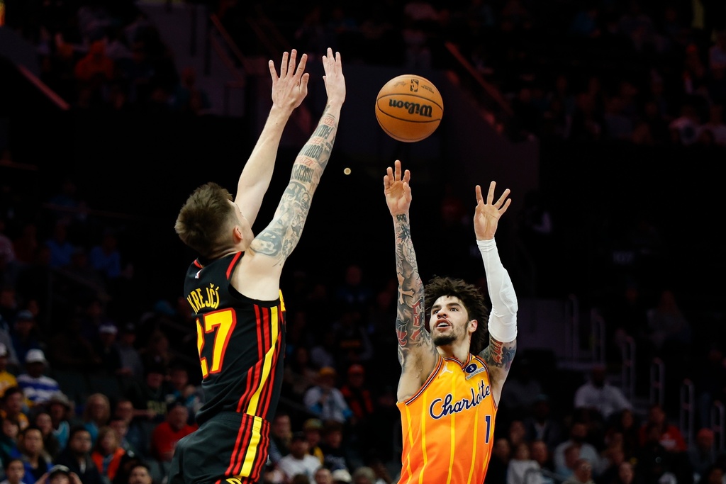 Charlotte Hornets guard LaMelo Ball (1) shoots against Atlanta Hawks guard Vit Krejci, left, during the first half of an NBA basketball game in Charlotte, N.C., Thursday, Dec. 18, 2025. (AP Photo/Nell Redmond)