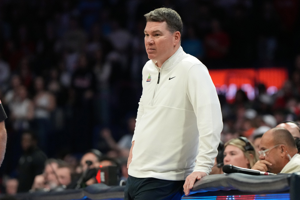 Arizona head coach Tommy Lloyd watches action against West Virginia during the second half of an NCAA college basketball game, Saturday, Jan. 24, 2026, in Tucson, Ariz. (AP Photo/Rick Scuteri)