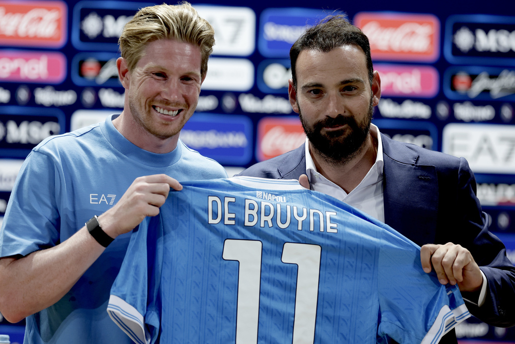 Napoli's Kevin De Bruyne, left, and Sports director Giovanni Manna hold a Napoli jersey in Dimaro, Italy, Saturday, July 19, 2025. (Alessandro Garofalo/LaPresse via AP)