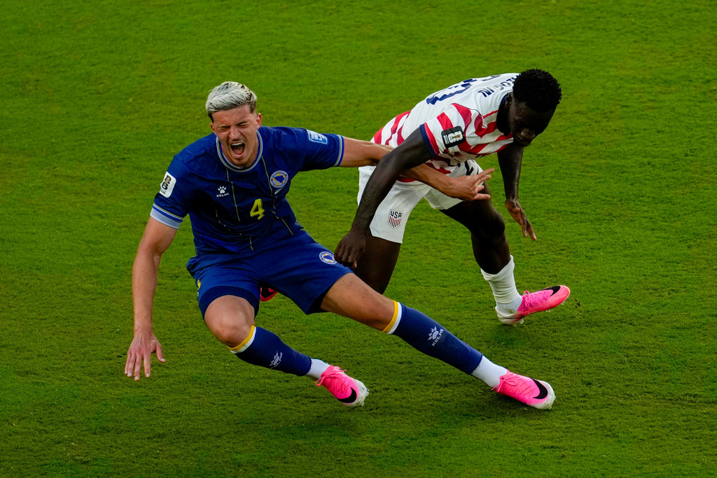 United States' Folarin Balogun (20) fouls Bosnia's Tarik Muharemovic (4) during the World Cup round of 32 soccer match between the United States and Bosnia in Santa Clara, Calif., near San Francisco, Wednesday, July 1, 2026. Balogun received a red card on the play. (AP Photo/Jeff Chiu)