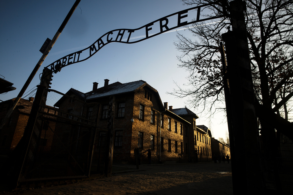 FILE - The sun lights the buildings behind the entrance of the former Nazi death camp Auschwitz-Birkenau in Oswiecim, Germany, Dec. 6, 2019. (Photo/Markus Schreiber, File)