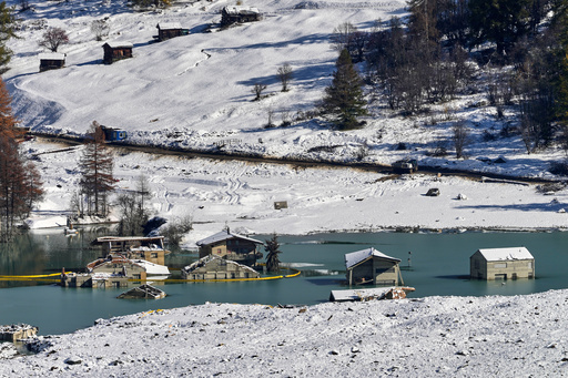 Picture shows the partly flooded village of Blatten after recent snowfalls, five months after a landslide destroyed the village, Blatten, Switzerland, on Tuesday, Oct. 28, 2025. (AP Photo/Michael Probst) Picture shows the partly flooded village of Blatten after recent snowfalls, five months after a landslide destroyed the village, Blatten, Switzerland, on Tuesday, Oct. 28, 2025. (AP Photo/Michael Probst)
