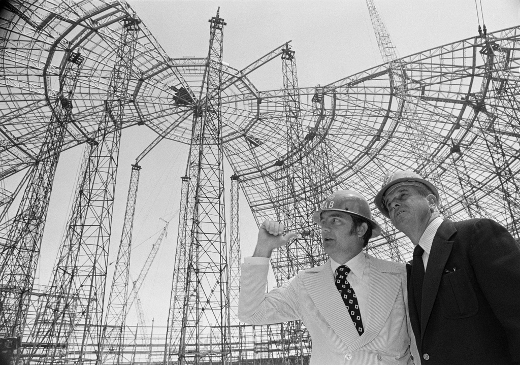 FILE - New York Mets general manager Robert Scheffing, right, chats with stadium official Bill Connick under the roof of the dome stadium that is under construction in New Orleans, April 2, 1973. (AP Photo/Jack Thornell, File)