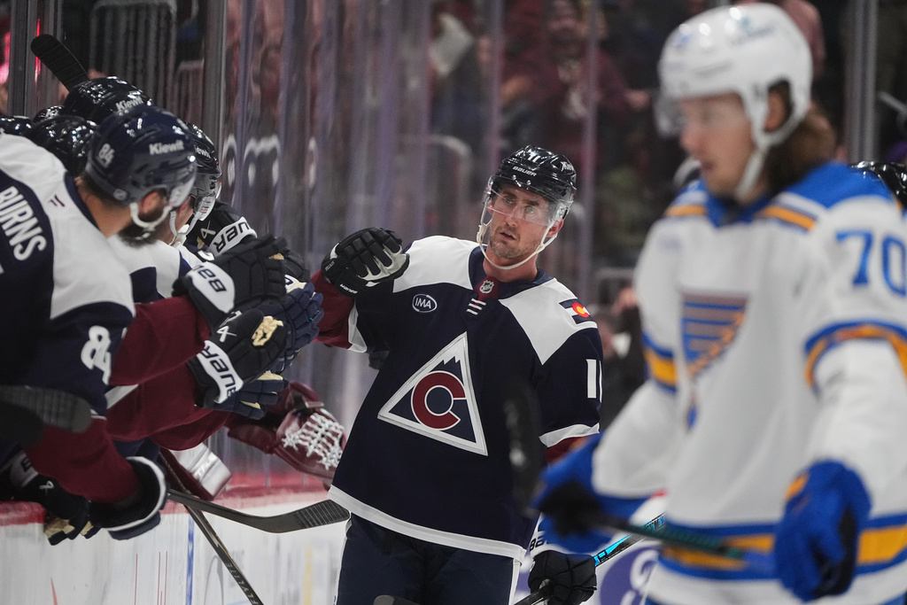 Colorado Avalanche center Brock Nelson is congratulated as he passes the team box after scoring a goal against the St. Louis Blues in the second period of an NHL hockey game, Wednesday, Dec. 31, 2025, in Denver. (AP Photo/David Zalubowski)