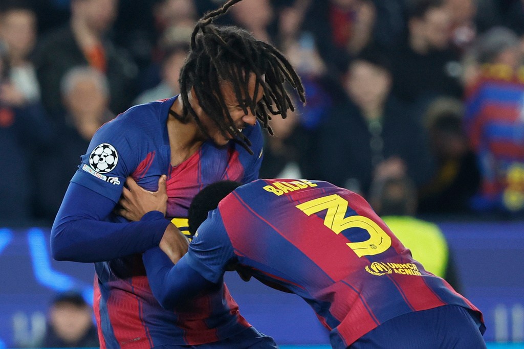 Barcelona's Jules Kounde left, celebrates with Alejandro Balde after scoring his side's second goal during the Champions League opening phase soccer match between Barcelona and Eintracht Frankfurt in Barcelona, Spain, Tuesday, Dec. 9, 2025. (AP Photo/Joan Monfort)