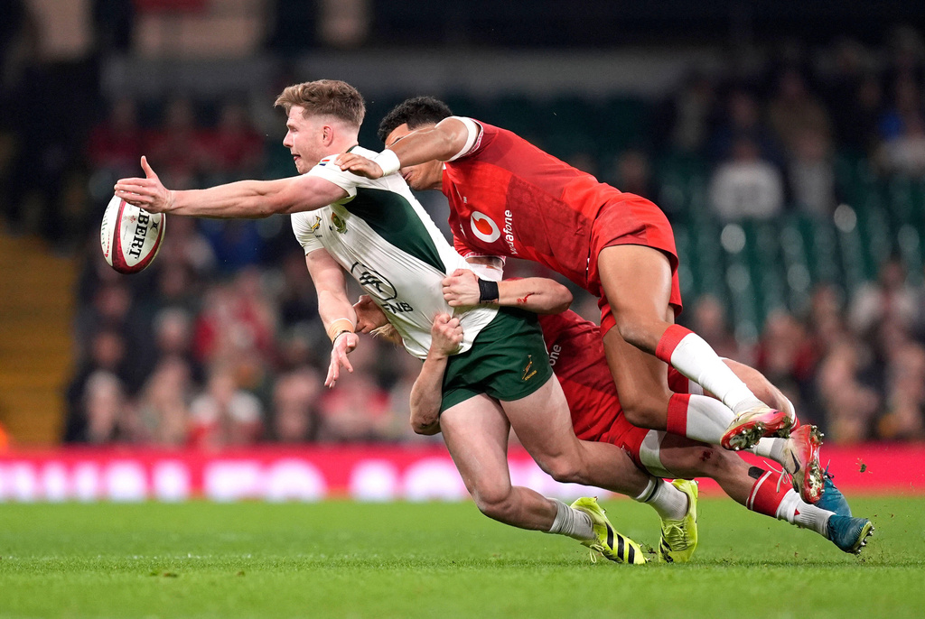 South Africa's Ethan Hooker is tackled by Wales's Blair Murray and Rio Dyer during the rugby union international match between Wales and South Africa in Cardiff, Wales, Saturday Nov. 29, 2025. (Andrew Matthews/PA via AP)