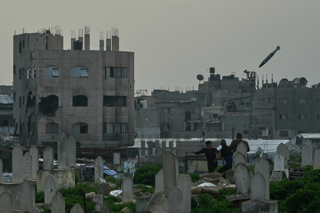 A bomb flies in the air as it approaches a building during an Israeli military strike in the Zeitoun neighborhood of Gaza City, Friday, Feb. 6, 2026. (AP Photo/Jehad Alshrafi)