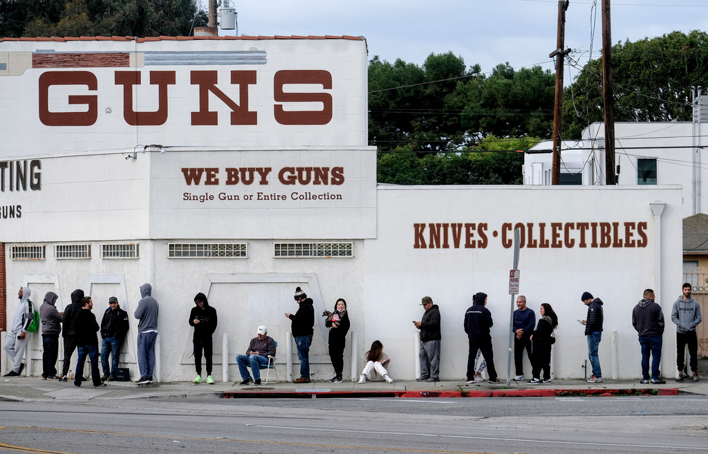 FILE - People wait to enter a gun store in Culver City, Calif., March 15, 2020. (AP Photo/Ringo H.W. Chiu, File)