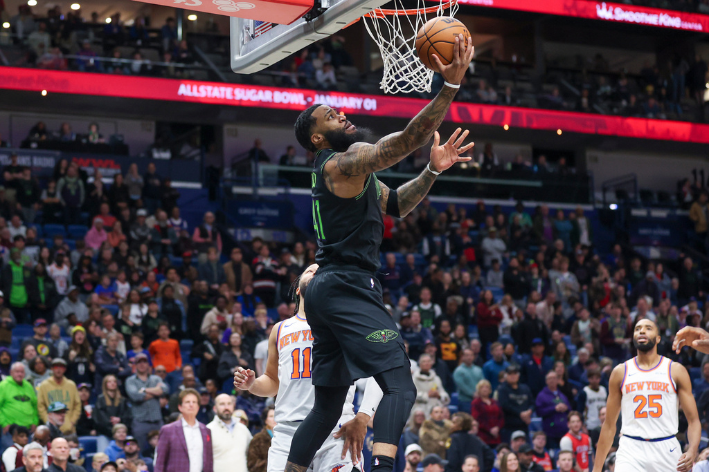 New Orleans Pelicans guard Saddiq Bey (41) gets past New York Knicks guard Jalen Brunson (11) for a reverse layup in the first half of an NBA basketball game in New Orleans, Monday, Dec. 29, 2025. (AP Photo/Peter Forest)