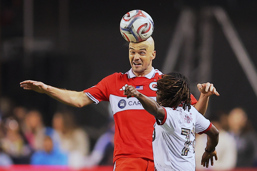 Chicago Fire defender Andrew Gutman, middle, heads the ball over Toronto FC midfielder Malik Henry during the second half of an MLS soccer match Saturday, May 23, 2026, in Chicago. (AP Photo/Melissa Tamez)