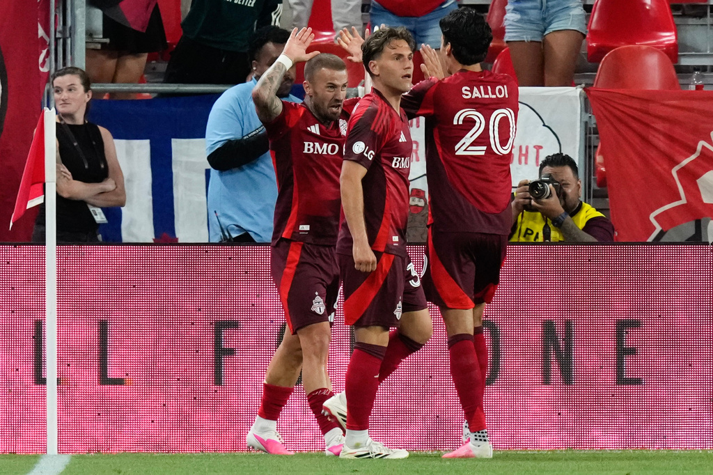 Toronto FC's Niklas Dorsch (left) celebrates with Daniel Salloi (20) and Jackson Gilman (38) after scoring against Charlotte FC during the second half of a MLS soccer game in Toronto, Wednesday, Aug. 19, 2026. (Chris Young/The Canadian Press via AP)
