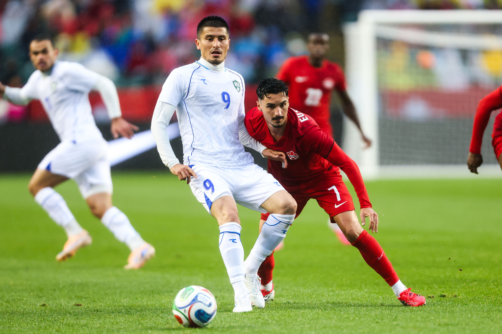 Canada's Stephen Eustaquio (7) battles against Uzbekistan's Odiljon Xamrobekov (9) during the first half of an international friendly soccer match in Edmonton, Alberta, Monday, June 1, 2026. (Codie McLachlan/The Canadian Press via AP)