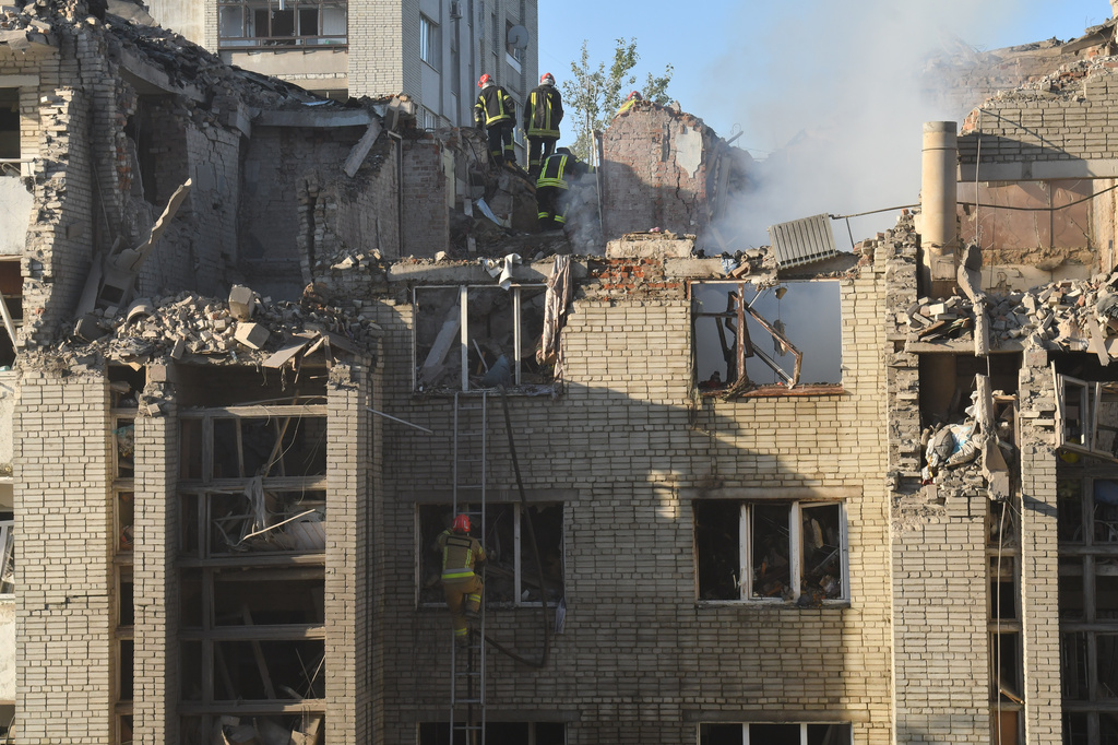 Rescuers search through the rubble of a residential building following air attack in Lviv, Ukraine, Thursday, July 30, 2026. (AP Photo/Mykola Tys)