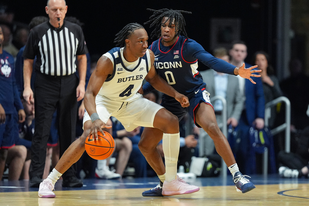 Butler forward Efeosa Oliogu-Elabor (4) drives on UConn guard Malachi Smith (0) in the first half of an NCAA college basketball game in Indianapolis, Wednesday, Feb. 11, 2026. (AP Photo/Michael Conroy)
