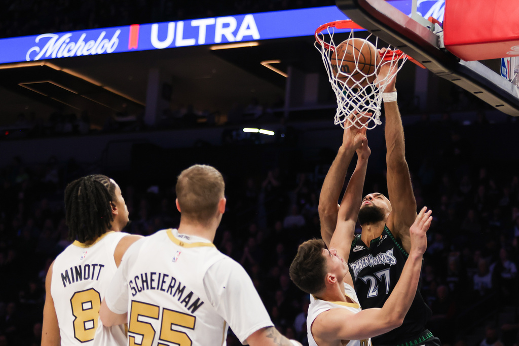 Minnesota Timberwolves' Rudy Gobert (27) scores a basket during a game against the Boston Celtics during the first half of an NBA basketball game, Saturday, Nov. 29, 2025, in Minneapolis. (AP Photo/Lily Dozier)