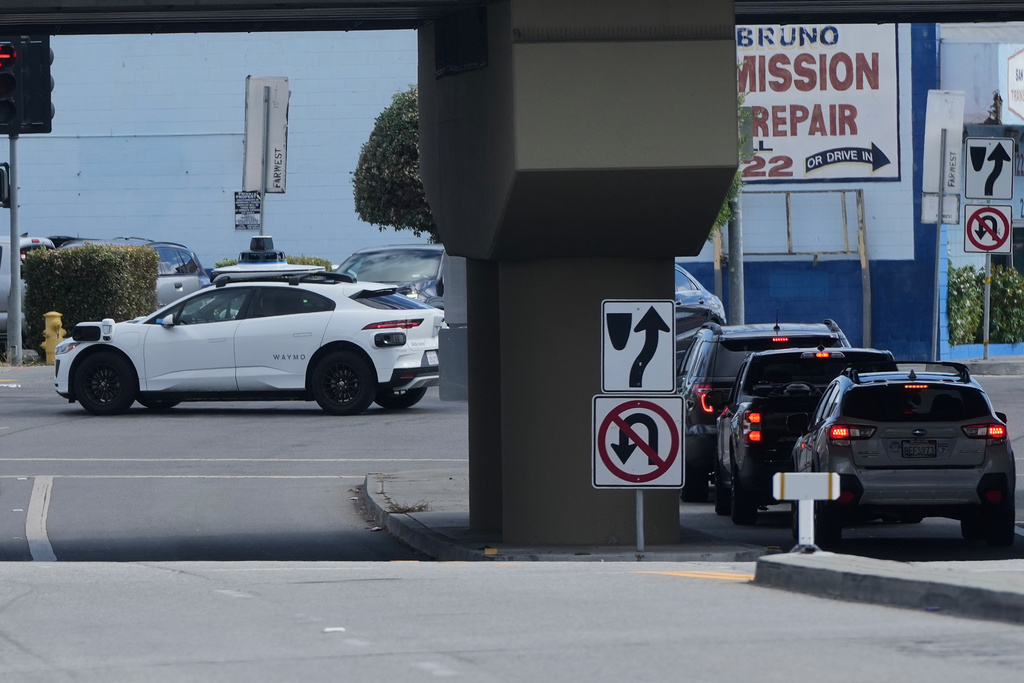 A Waymo vehicle makes a left turn in San Bruno, Calif., Tuesday, Sept. 30, 2025. (AP Photo/Jeff Chiu)