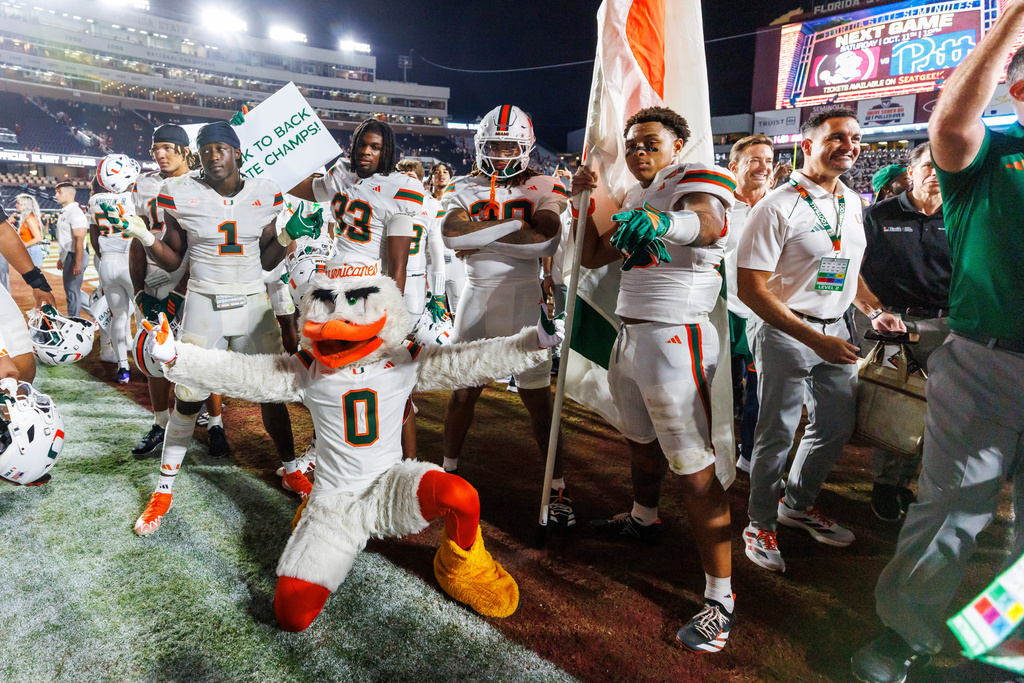 Miami players and the team mascot Sebastian the Ibis celebrate defeating Florida State in a NCAA college football game, Saturday, Oct. 4, 2025, in Tallahassee, Fla. (AP Photo/Colin Hackley)
