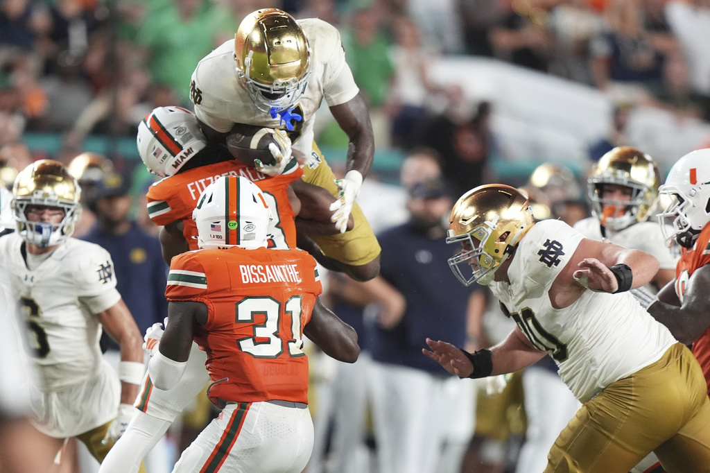Notre Dame running back Jeremiyah Love leaps up as he runs during the second half of an NCAA college football game against Miami, Sunday, Aug. 31, 2025, in Miami Gardens, Fla. (AP Photo/Lynne Sladky)