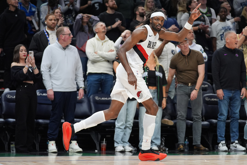 Portland Trail Blazers forward Jerami Grant (9) celebrates after making a 3-point shot during the second half of an NBA basketball game against the Minnesota Timberwolves, Friday, March 20, 2026, in Minneapolis. (AP Photo/Abbie Parr)