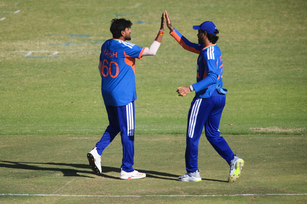 India's bowler Yash Thakur, right, celebrates with teammate Tilak Varma, after taking a wicket during the third T20 cricket match between Zimbabwe and India in Harare, Zimbabwe, Sunday, July 26, 2026. (AP Photo/Wonder Mashura)