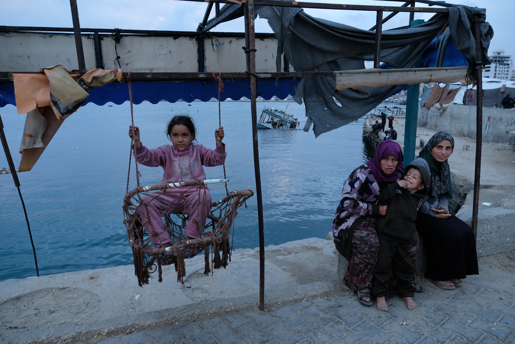 A Palestinian girl sits on a swing in the port of Gaza City on the Mediterranean Sea, Saturday, Dec. 6, 2025. (AP Photo/Jehad Alshrafi)