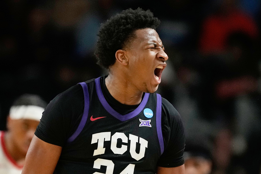 TCU forward Xavier Edmonds (24) celebrates scoring during the first half in the first round of the NCAA college basketball tournament against Ohio State, Thursday, March 19, 2026, in Greenville, S.C. (AP Photo/Brynn Anderson)