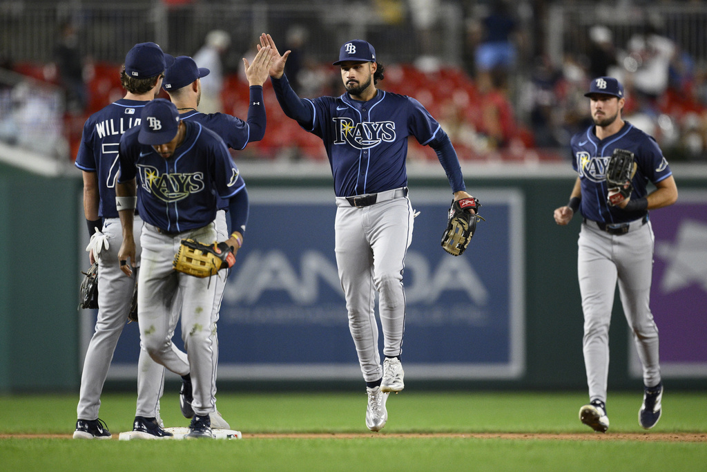 Tampa Bay Rays' Everson Pereira, center, and others celebrate after a baseball game against the Washington Nationals, Friday, Aug. 29, 2025, in Washington. (AP Photo/Nick Wass)