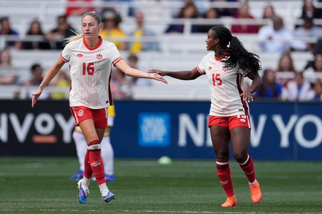 Canada forward Janine Sonis (16) celebrates her goal with teammate Nichelle Prince (15) during the second half of a SheBelieves Cup women's soccer tournament match Sunday, March 1, 2026, in Nashville, Tenn. (AP Photo/George Walker IV)