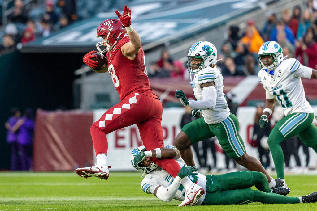 Temple tight end Peter Clarke, top left, is tackled by Tulane safety Bailey Despanie, bottom, during the first half of an NCAA college football game, Saturday, Nov. 22, 2025, in Philadelphia. (AP Photo/Laurence Kesterson)