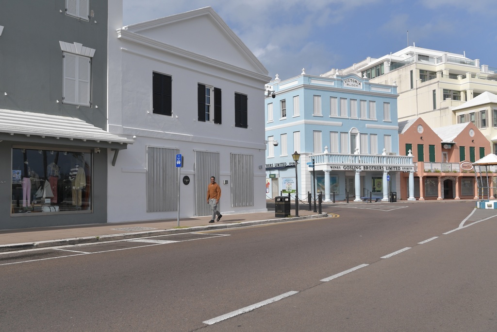 A man walks down a street with closed businesses ahead of Hurricane Imelda's expected arrival in Hamilton, Bermuda, Wednesday, Oct. 1, 2025. (AP Photo/Anthony Wade)