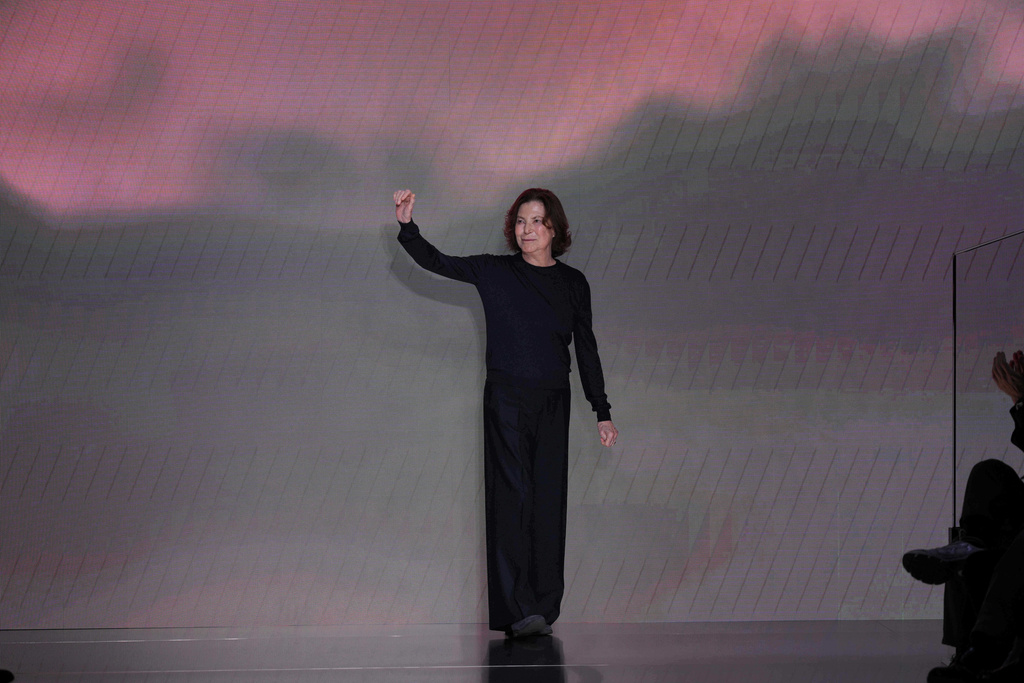 Silvana Armani is greeted by the public at the end of the Giorgio Armani Fall/Winter 2026-2027 Women's collection presented in Milan, Italy, Sunday, March 1, 2026. (AP Photo/Antonio Calanni)