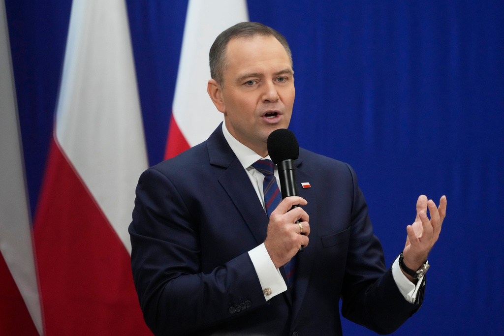 Polish President Karol Nawrocki meets senior citizens and signs a draft law to their benefit during a visit to the public library in Sochaczew, near Warsaw, Poland, Monday, Nov. 3, 2025. (AP Photo/Czarek Sokolowski)