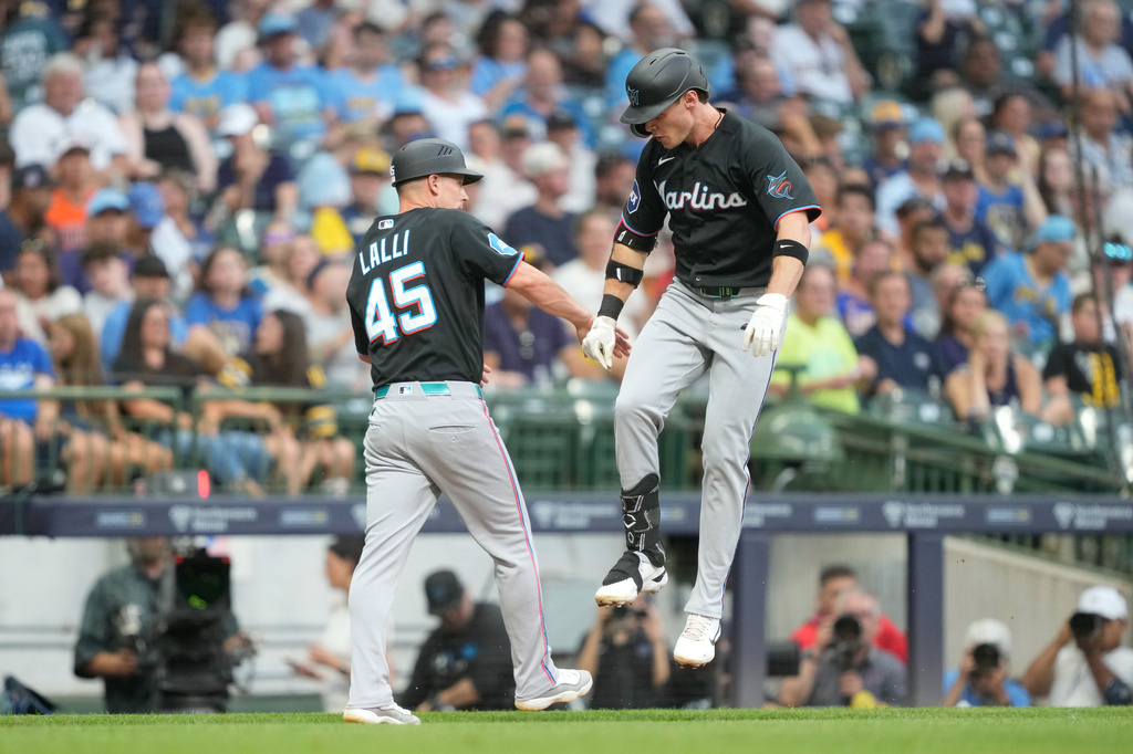 Miami Marlins' Griffin Conine, right, celebrates with third base coach Blake Lalli (45) after hitting a home run during the fifth inning of a baseball game against the Milwaukee Brewers, Friday, July 17, 2026, in Milwaukee. (AP Photo/Kayla Wolf)